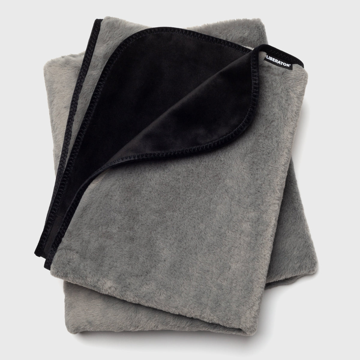 Folded gray blanket with black interior on a light gray background