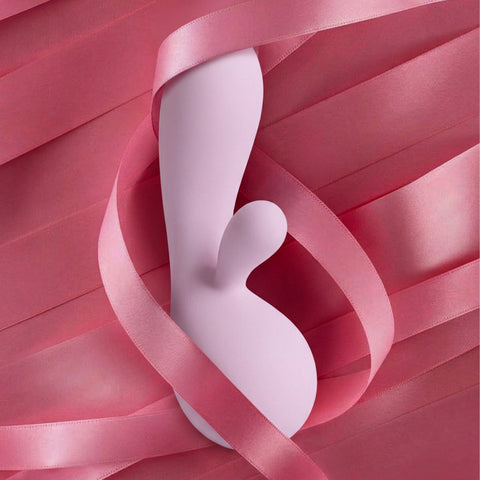 Purple rabbit vibrator surrounded by pink ribbons