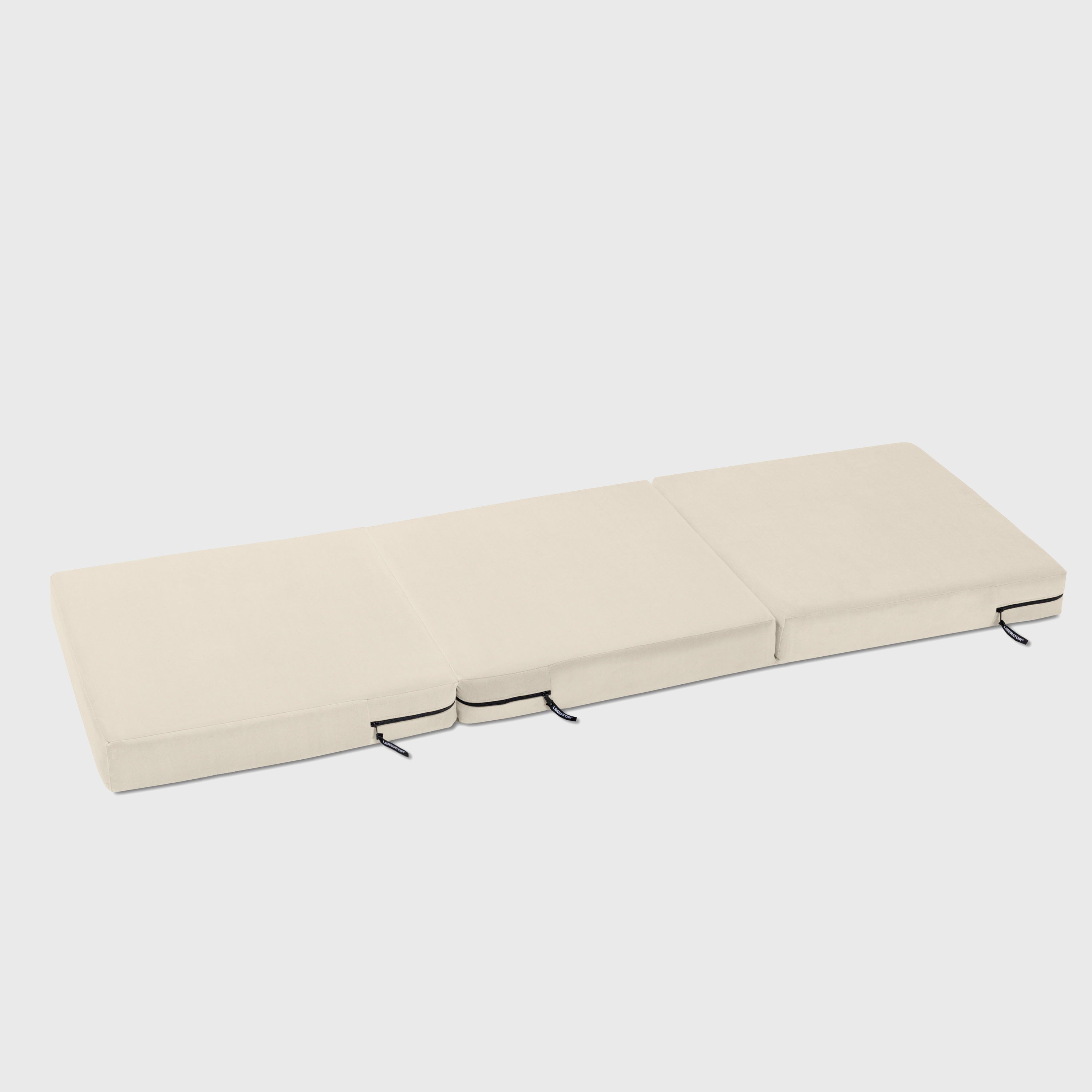 Beige folding mattress on a white background