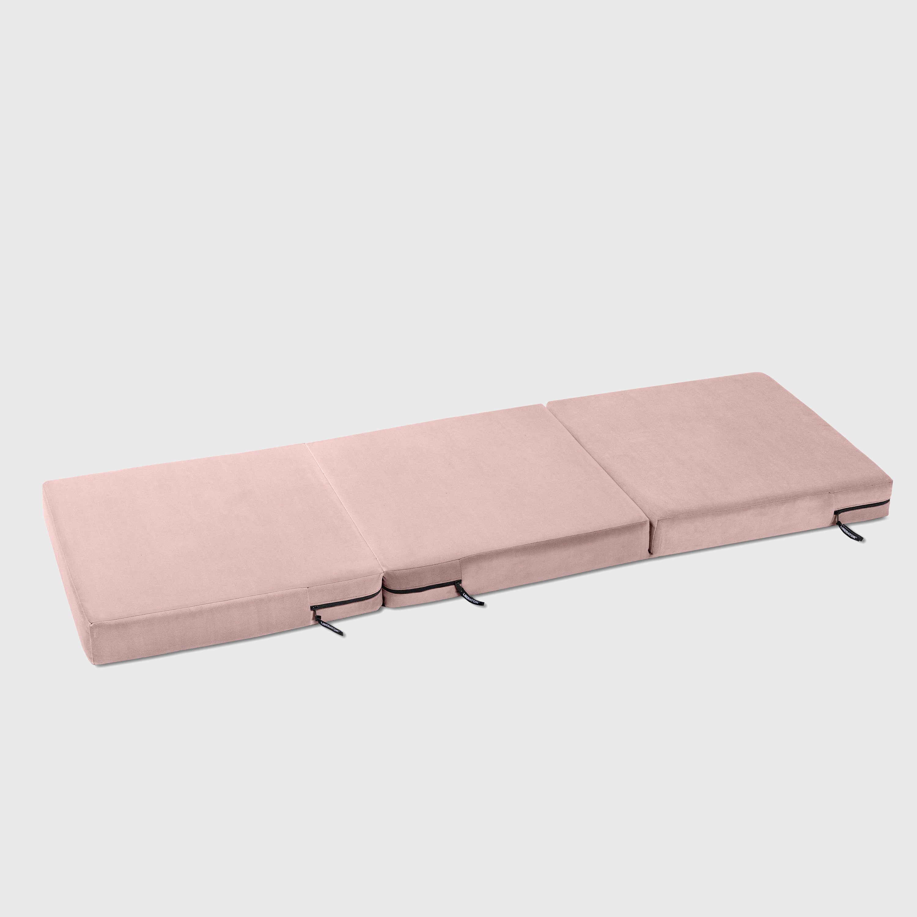Pink folding mattress on a white background