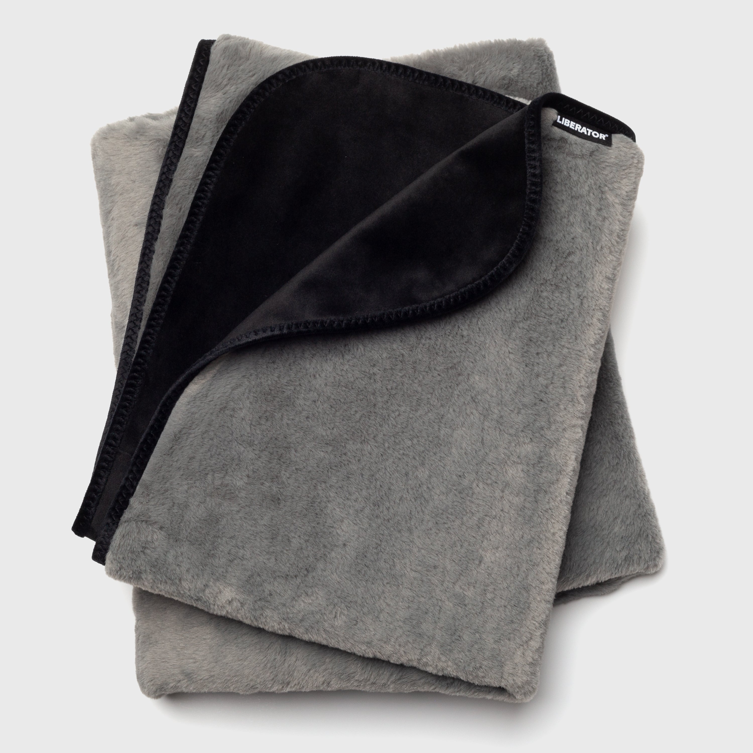 Folded gray blanket with black interior on a light gray background