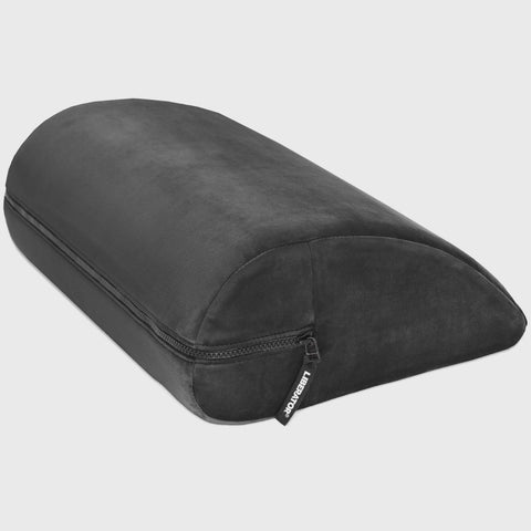 Black wedge-shaped pillow on a light gray background