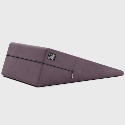 Purple ramp pillow with a brand logo on a light gray background