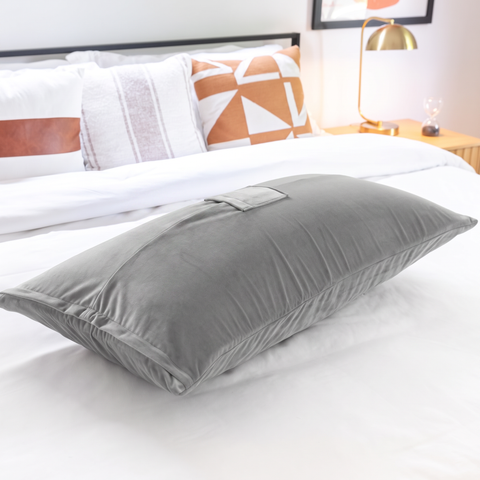 Humphrey toy-mount pillow styled on a bed in a bedroom